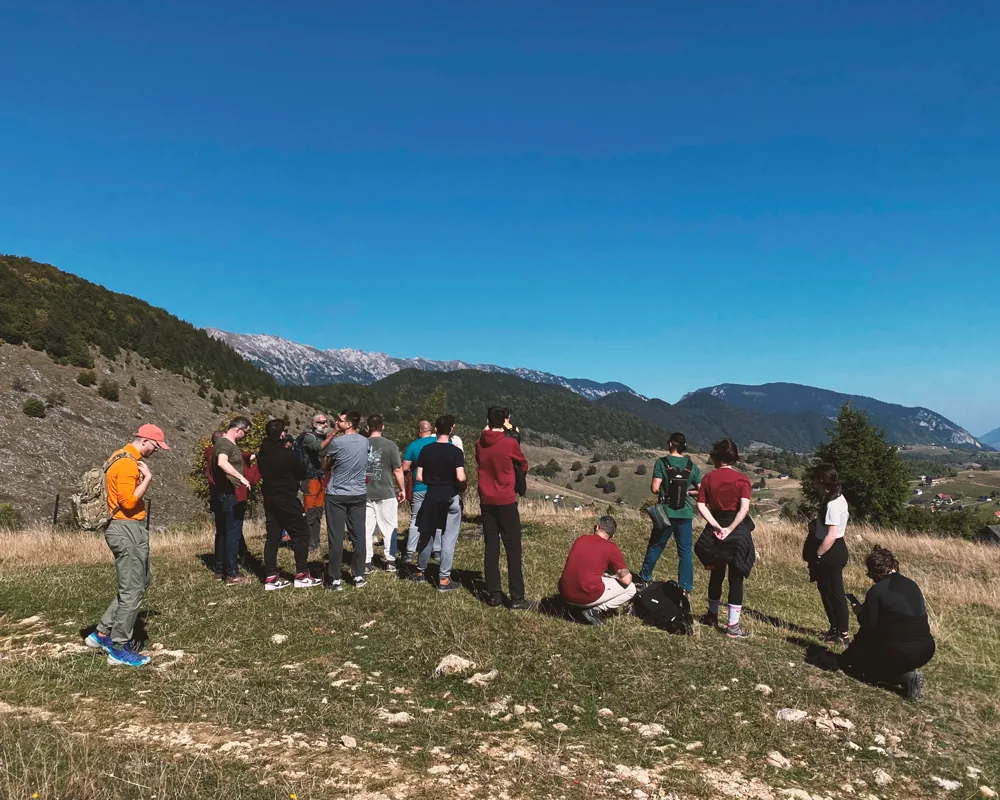 Teammates on a hike across a meadow