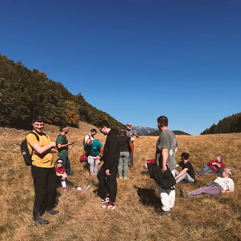 Teammates resting in a mountain valley